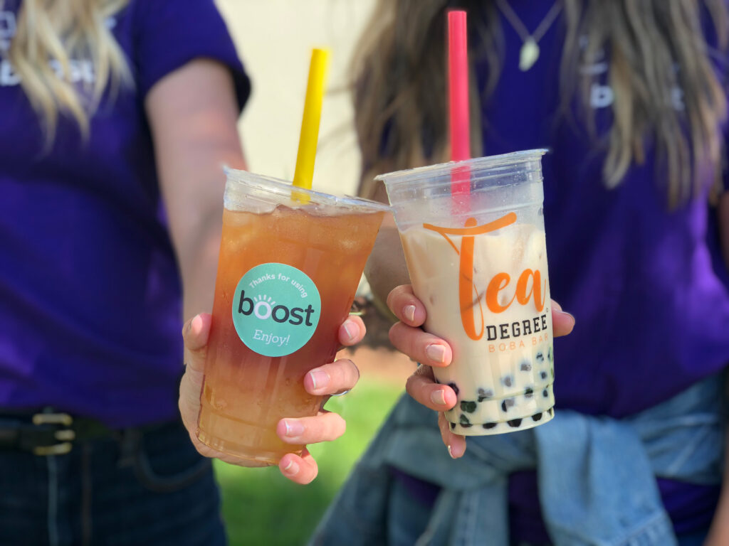 holding drinks with boost sticker